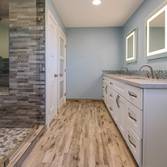 Bathroom Remodel Freshly remodeled bathroom with a lavishly designed and open shower plan You can get lost in there! The wood flooring and sink design 