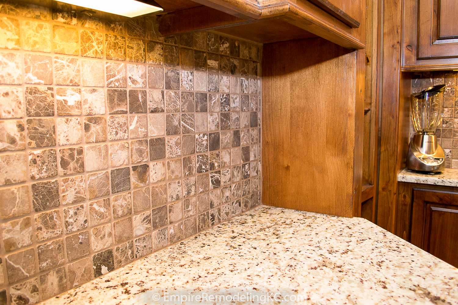 Deluxe Kitchen in Basement remodel with crawford ceilings, hidden doors, stone and granite bar, and living area.