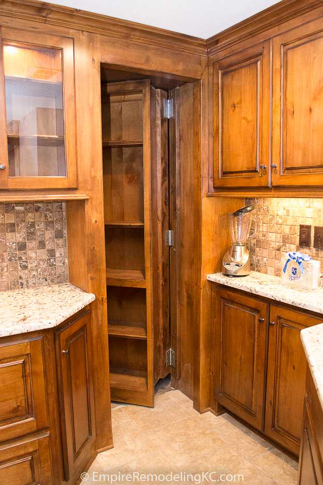 Deluxe Kitchen in Basement remodel with crawford ceilings, hidden doors, stone and granite bar, and living area.