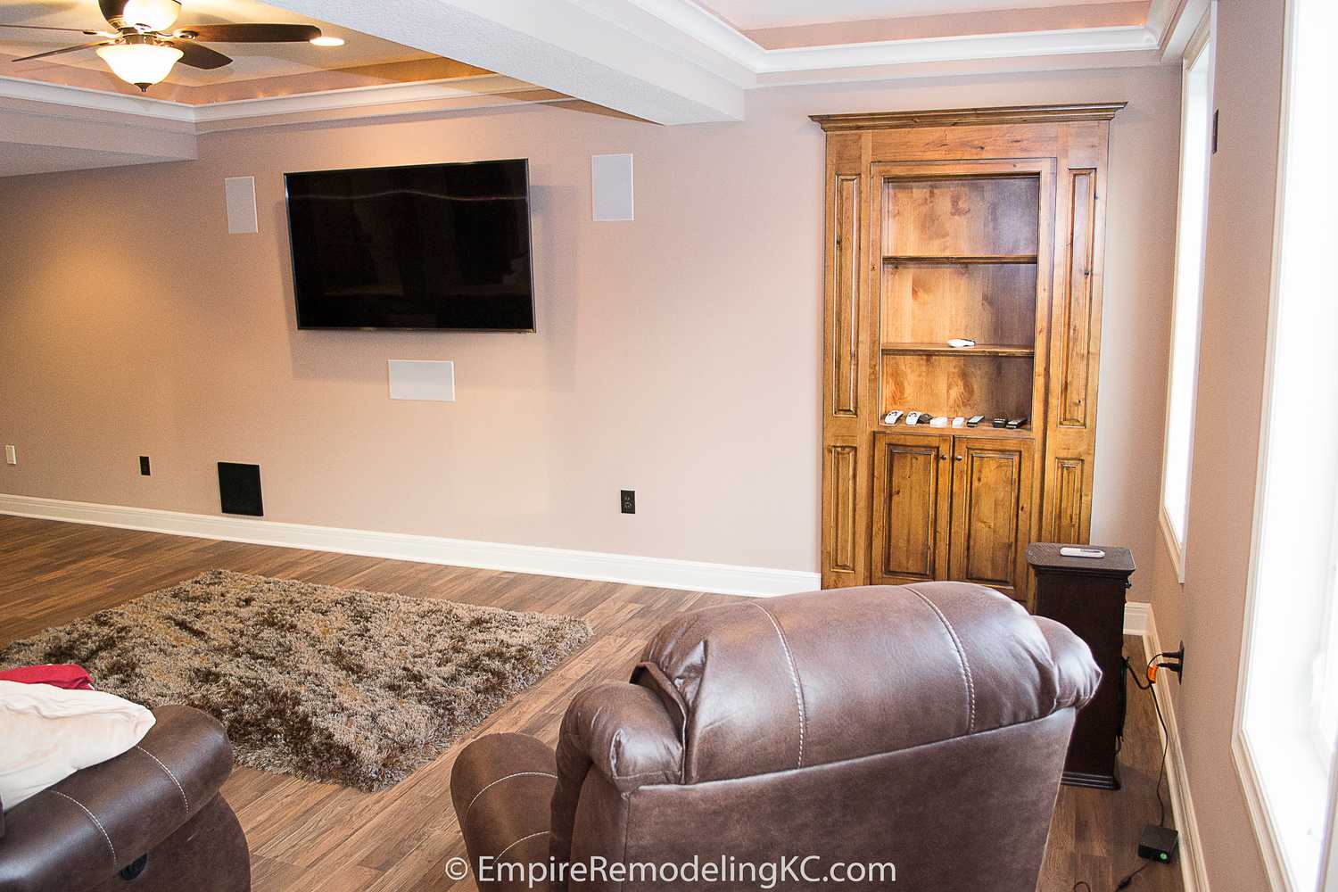 Deluxe Kitchen in Basement remodel with crawford ceilings, hidden doors, stone and granite bar, and living area.