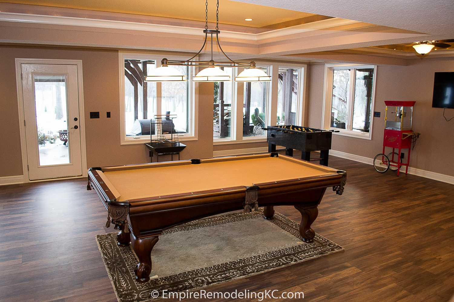 Deluxe Kitchen in Basement remodel with crawford ceilings, hidden doors, stone and granite bar, and living area.