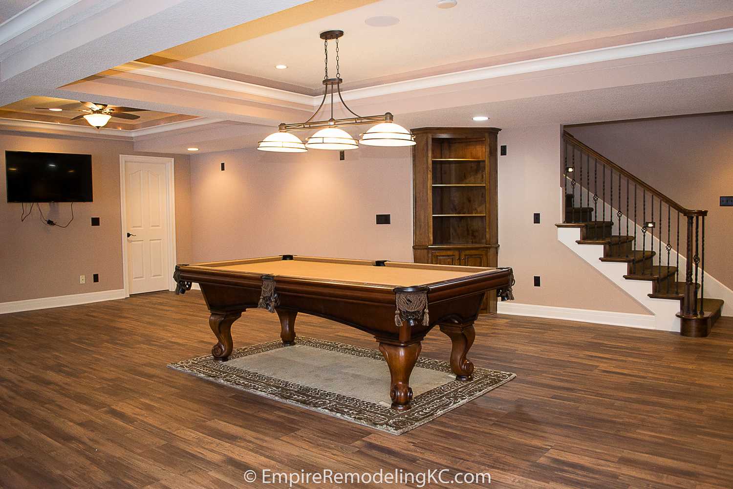 Deluxe Kitchen in Basement remodel with crawford ceilings, hidden doors, stone and granite bar, and living area.