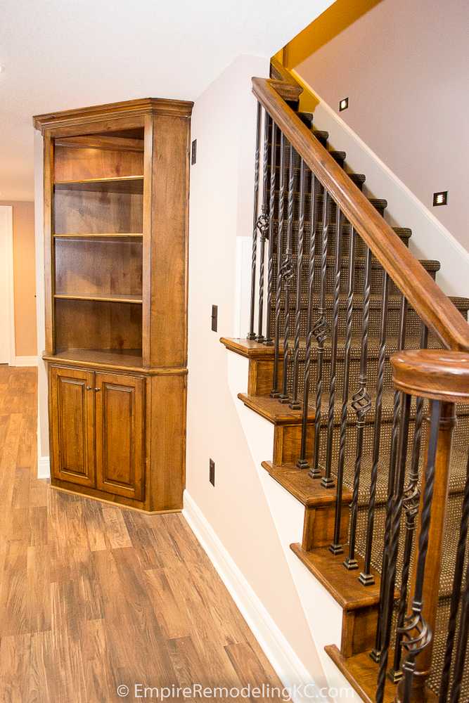 Deluxe Kitchen in Basement remodel with crawford ceilings, hidden doors, stone and granite bar, and living area.