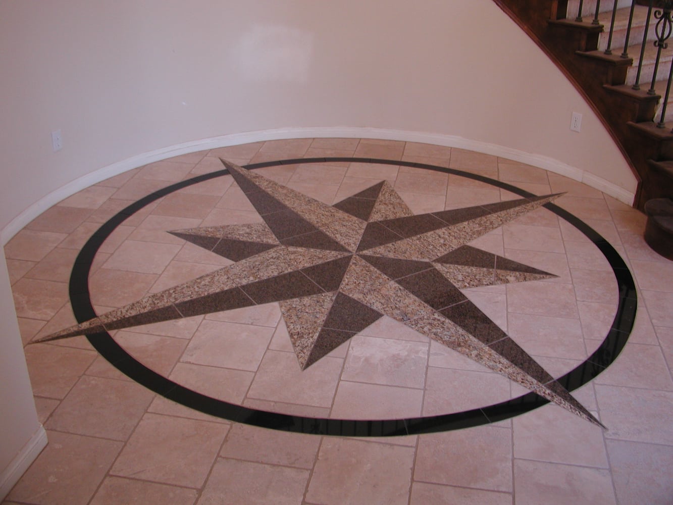 Custom 12' custom compass rose on the floor of a spiral stairwell