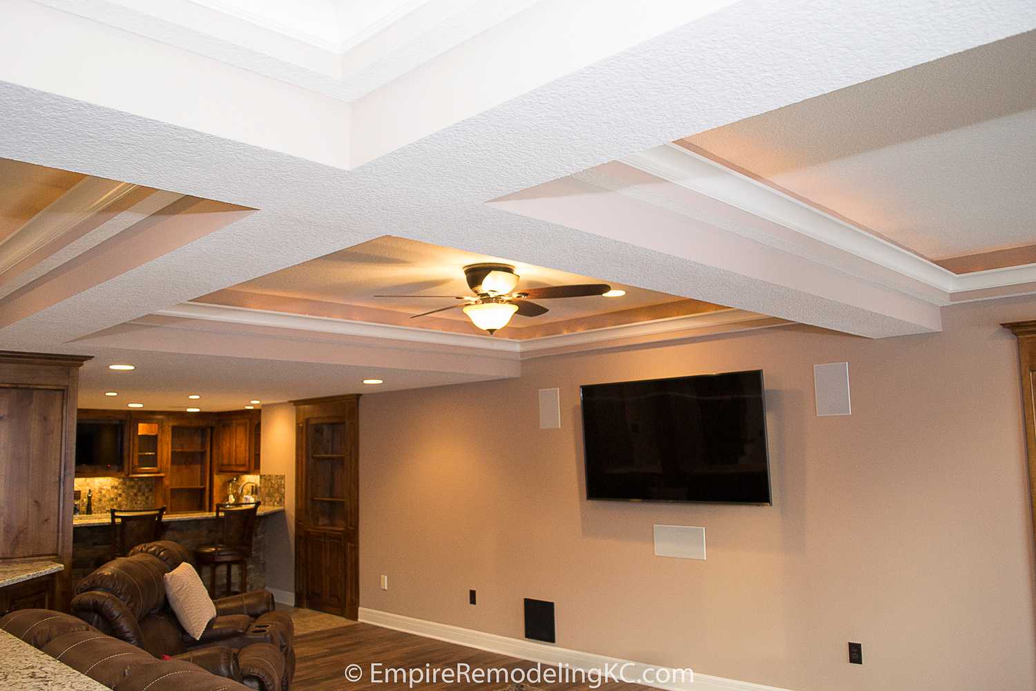 Deluxe Kitchen in Basement remodel with crawford ceilings, hidden doors, stone and granite bar, and living area.