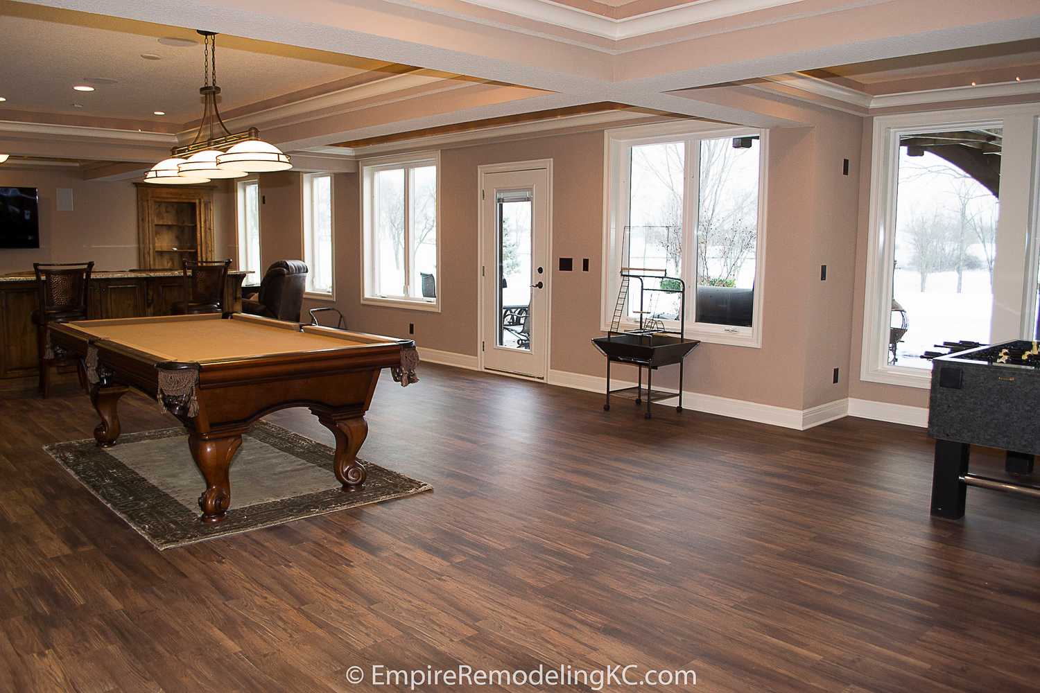 Deluxe Kitchen in Basement remodel with crawford ceilings, hidden doors, stone and granite bar, and living area.