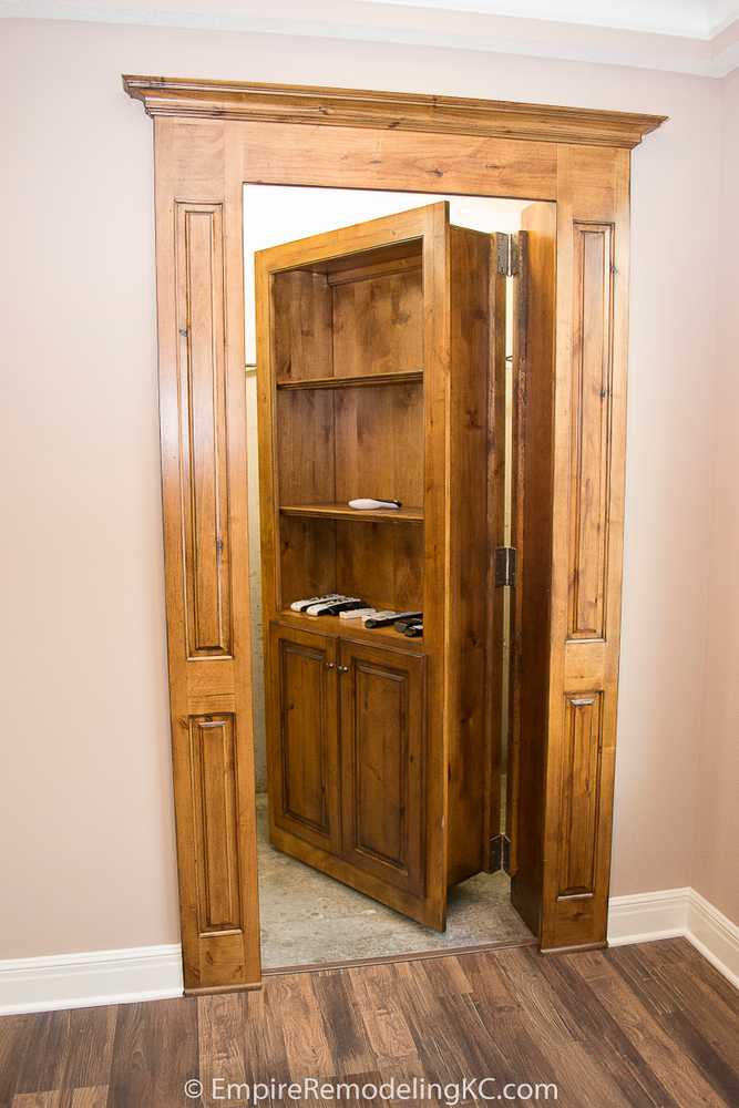 Deluxe Kitchen in Basement remodel with crawford ceilings, hidden doors, stone and granite bar, and living area.