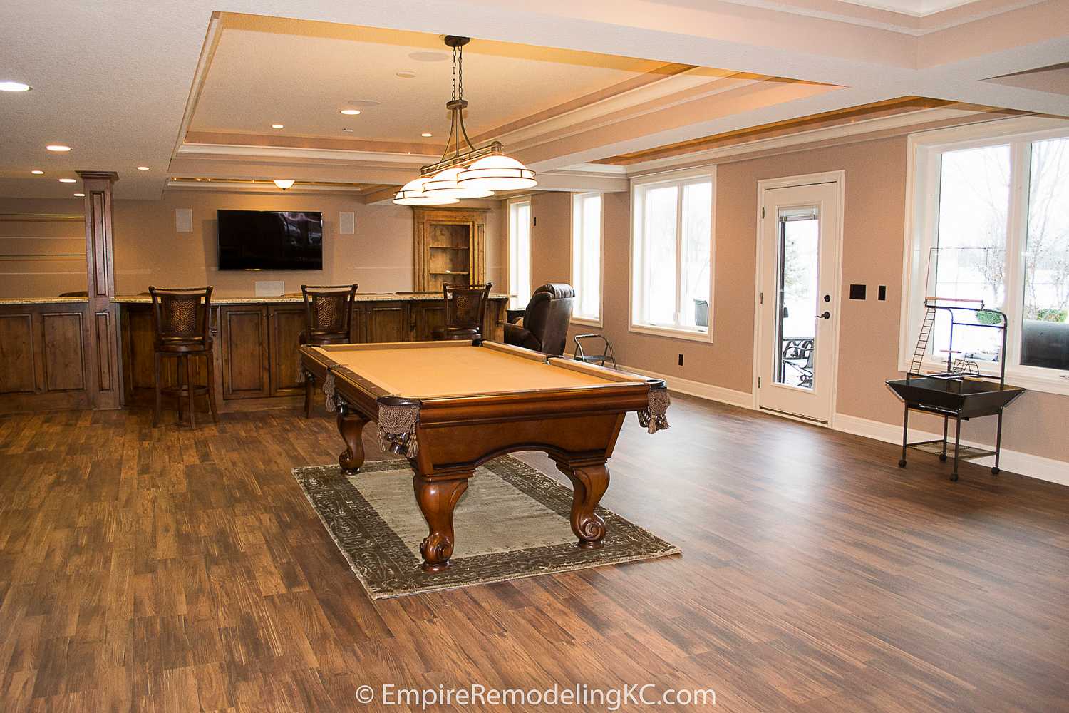 Deluxe Kitchen in Basement remodel with crawford ceilings, hidden doors, stone and granite bar, and living area.