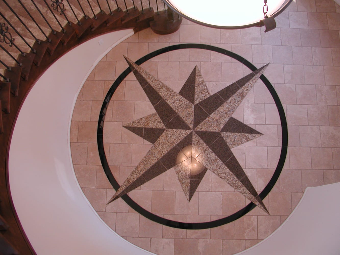 Custom 12' custom compass rose on the floor of a spiral stairwell