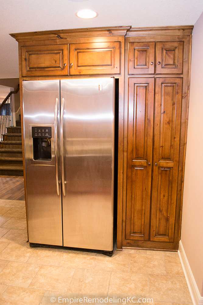 Deluxe Kitchen in Basement remodel with crawford ceilings, hidden doors, stone and granite bar, and living area.