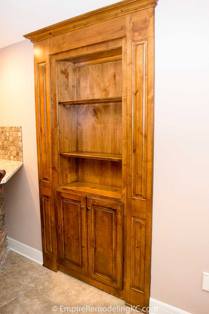 Deluxe Kitchen in Basement remodel with crawford ceilings, hidden doors, stone and granite bar, and living area.