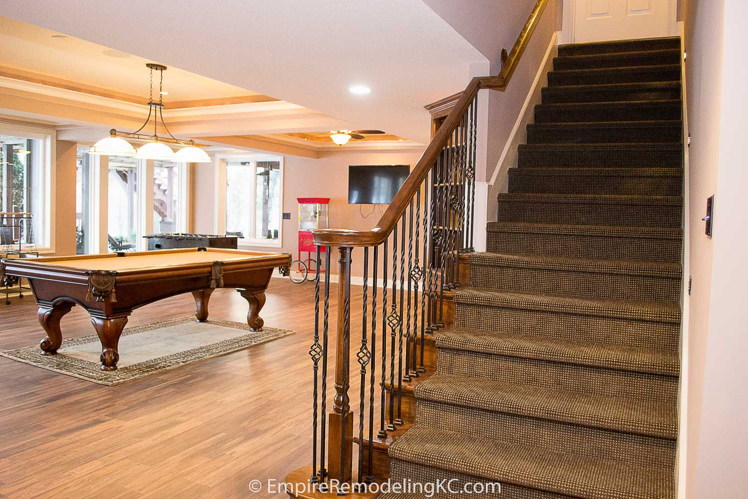 Deluxe Kitchen in Basement remodel with crawford ceilings, hidden doors, stone and granite bar, and living area.